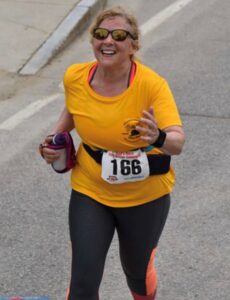 Deb at the finish line of the Red’s Shoe Barn 5 Mile Race