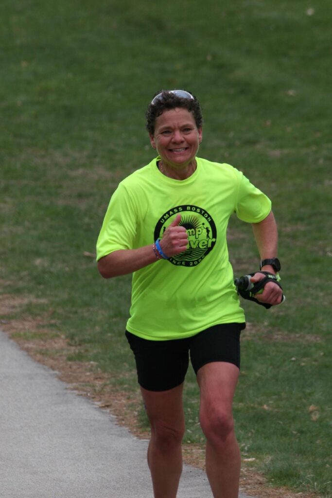Amanda McCann smiling and running in a Camp Shriver T-shirt